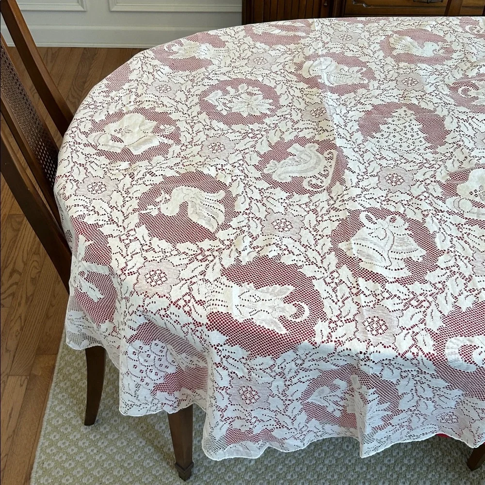 Vintage Quaker Lace tablecloth. 70‎ inch round. White lace over red liner.